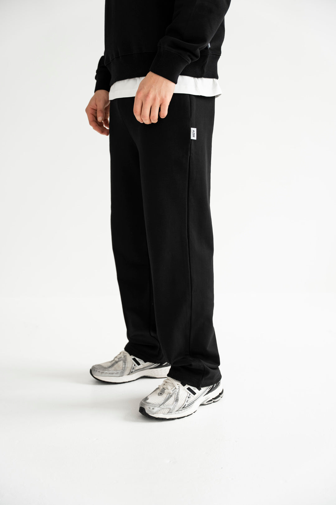 Male wearing black relaxed fit sweatpants