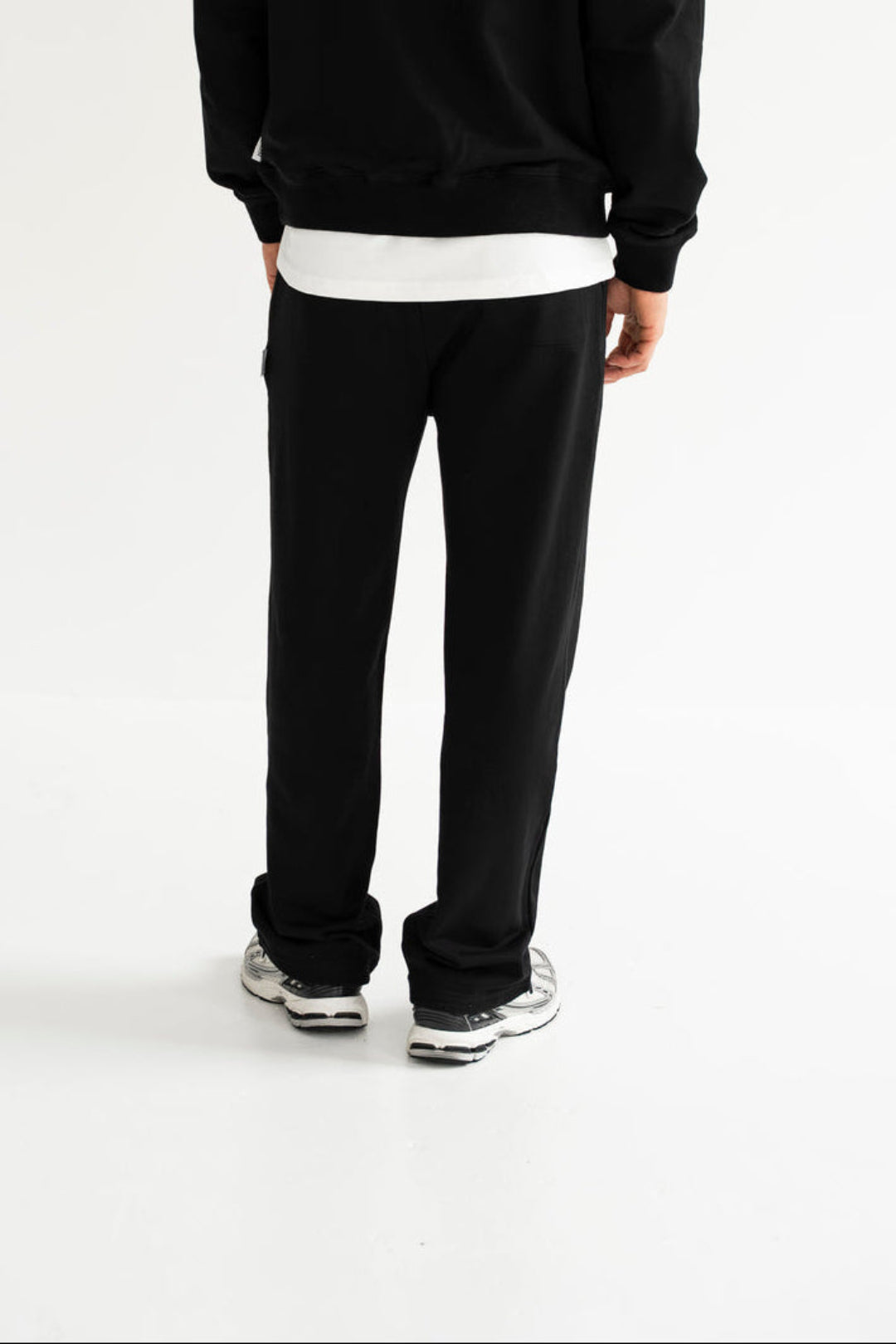 Man wearing a black tracksuit on a white background